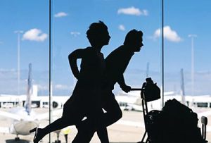 Two people running through an airport.